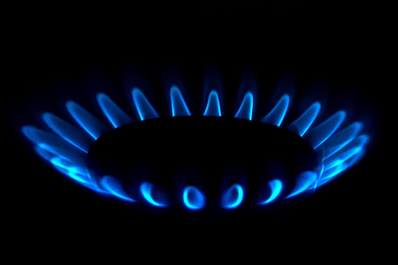 A ring of blue gas flames burning in the dark